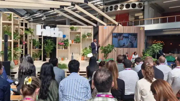 Federico Acosta presenting at HLTH Europe stage with live audience